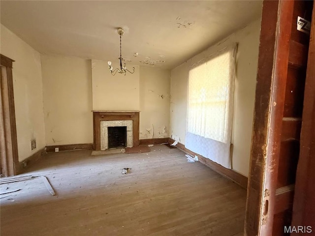 4753 Maffitt Ave, Saint Louis, MO 63113 - unfurnished living room featuring a chandelier, a fireplace, baseboards, and wood finished floors