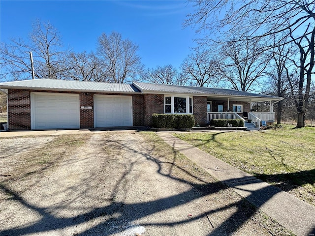 16892 Beaufort Rd, Crocker, MO 65452 - ranch-style home featuring brick siding, a porch, driveway, and metal roof