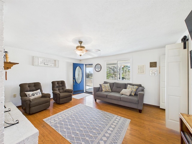 16892 Beaufort Rd, Crocker, MO 65452 - living area featuring light wood-style flooring, ceiling fan, and a textured ceiling