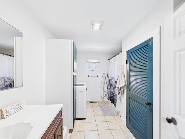 16892 Beaufort Rd, Crocker, MO 65452 - bathroom featuring vanity, tile patterned floors, and washer / clothes dryer
