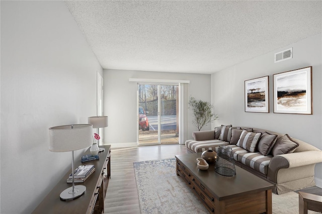 2781 Blackforest Dr Unit B, Saint Louis, MO 63129 - living room with a textured ceiling, wood finished floors, and baseboards