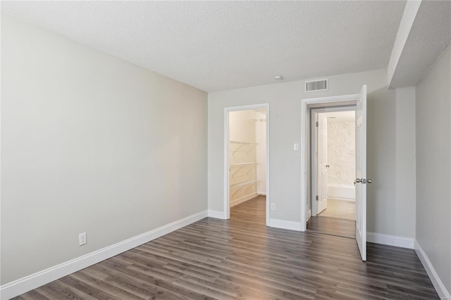2781 Blackforest Dr Unit B, Saint Louis, MO 63129 - unfurnished bedroom featuring dark wood finished floors, baseboards, and a textured ceiling