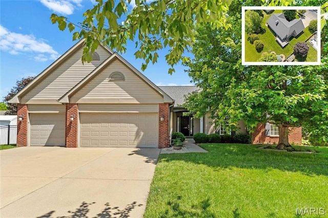 724 E Wesley Dr, Ofallon, IL 62269 - view of front of home featuring brick siding, a garage, concrete driveway, and a front yard