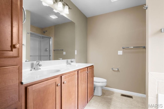 724 E Wesley Dr, Ofallon, IL 62269 - bathroom with a shower stall, toilet, baseboards, double vanity, and tile patterned floors