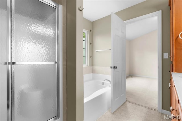 724 E Wesley Dr, Ofallon, IL 62269 - bathroom with vanity, a bath, a stall shower, and tile patterned flooring