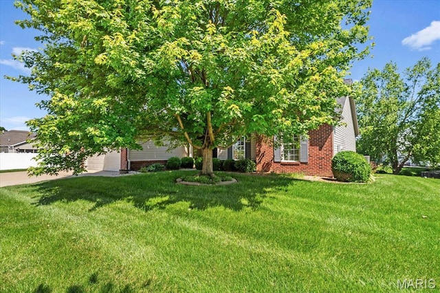 724 E Wesley Dr, Ofallon, IL 62269 - view of property hidden behind natural elements featuring brick siding, a front lawn, and driveway