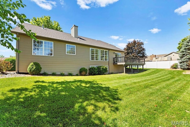 724 E Wesley Dr, Ofallon, IL 62269 - back of property with a chimney and a wooden deck