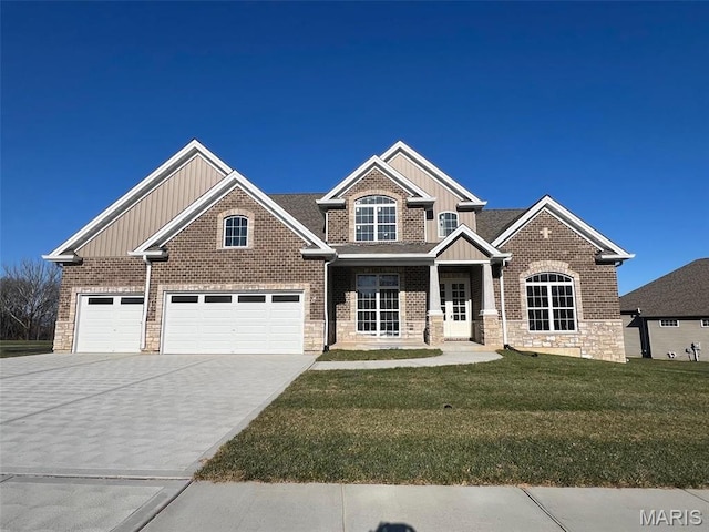 craftsman inspired home featuring board and batten siding, driveway, a front yard, and brick siding
