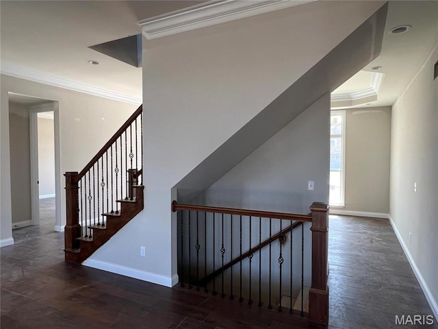 stairway featuring crown molding, baseboards, and wood finished floors