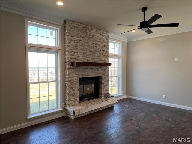 unfurnished living room featuring ornamental molding, baseboards, a ceiling fan, a fireplace, and dark wood-style flooring