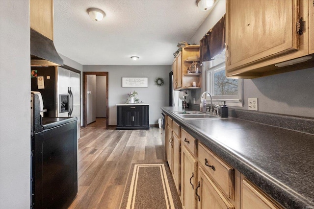 kitchen featuring open shelves, a sink, dark countertops, light wood-style floors, and under cabinet range hood