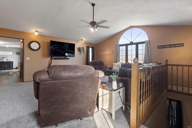 carpeted living room with lofted ceiling and a ceiling fan