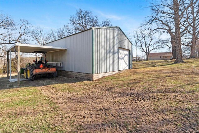 view of outbuilding with a carport and an outbuilding