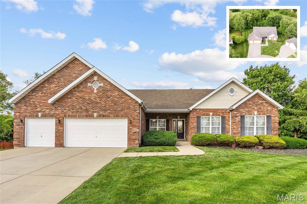 2293 Birmingham Dr, Shiloh, IL 62221 - view of front of property featuring an attached garage, driveway, a front lawn, and brick siding