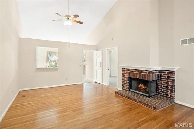 7310 Westover Colonial Ln, Saint Louis, MO 63119 - unfurnished living room featuring ceiling fan, wood finished floors, a brick fireplace, baseboards, and high vaulted ceiling