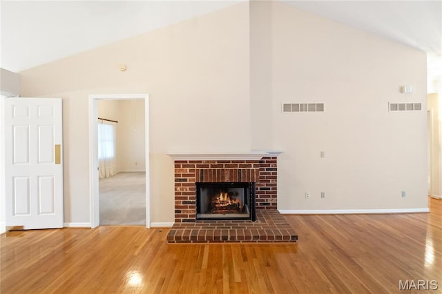 7310 Westover Colonial Ln, Saint Louis, MO 63119 - unfurnished living room featuring high vaulted ceiling, a fireplace, wood finished floors, and baseboards