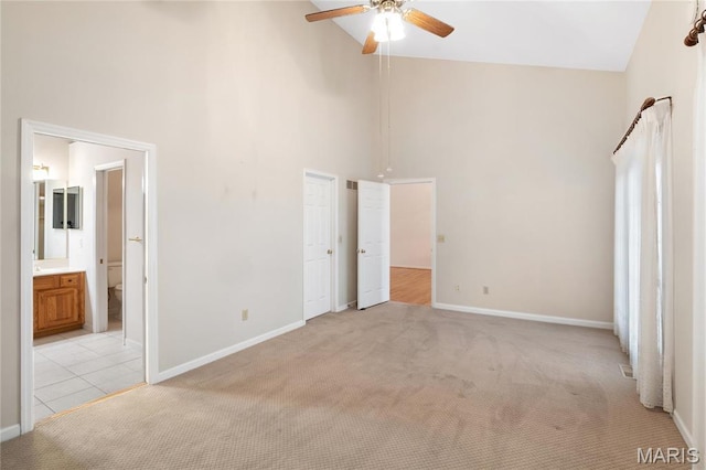7310 Westover Colonial Ln, Saint Louis, MO 63119 - unfurnished bedroom featuring high vaulted ceiling, light colored carpet, baseboards, and ensuite bathroom