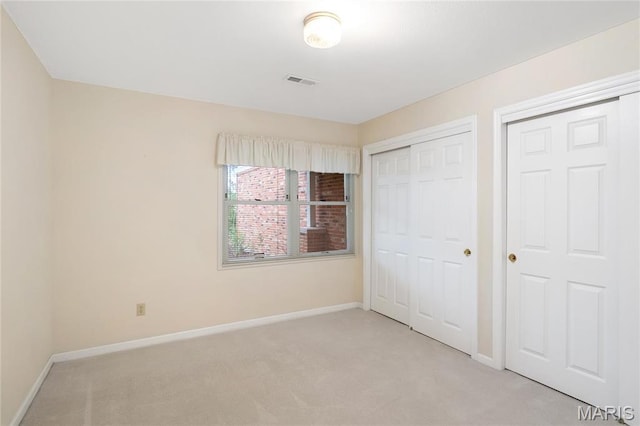 7310 Westover Colonial Ln, Saint Louis, MO 63119 - unfurnished bedroom with light colored carpet and baseboards