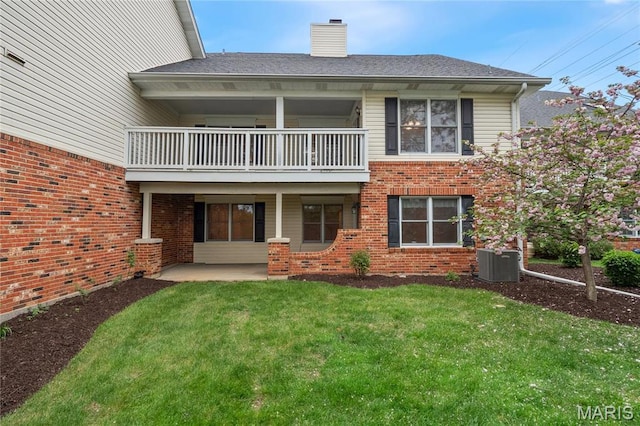 7310 Westover Colonial Ln, Saint Louis, MO 63119 - rear view of house with a balcony, cooling unit, a yard, a chimney, and brick siding