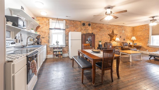 305 S Alvarado Ave, Belle, MO 65013 - dining space featuring a ceiling fan, brick wall, dark wood finished floors, and baseboards
