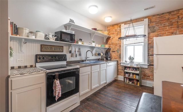 305 S Alvarado Ave, Belle, MO 65013 - kitchen featuring a sink, open shelves, white appliances, brick wall, and dark wood-style floors
