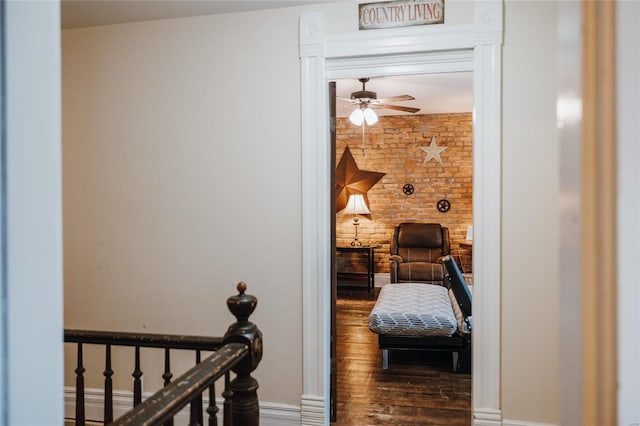 305 S Alvarado Ave, Belle, MO 65013 - hallway featuring wood finished floors, baseboards, an upstairs landing, and brick wall