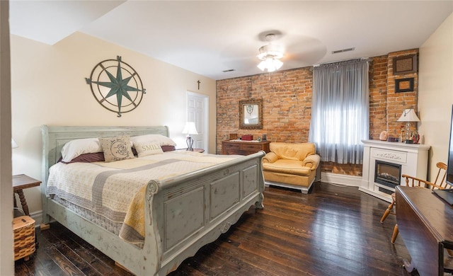305 S Alvarado Ave, Belle, MO 65013 - bedroom featuring dark wood-style flooring, brick wall, a fireplace, and a ceiling fan
