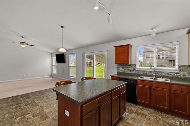 kitchen with black dishwasher, a sink, dark countertops, and plenty of natural light