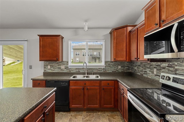 kitchen with stainless steel appliances, a sink, dark countertops, backsplash, and dark brown cabinets