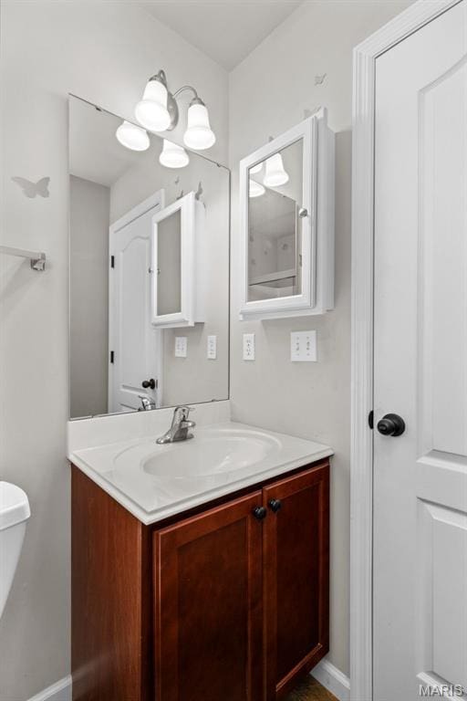 bathroom with vanity and baseboards
