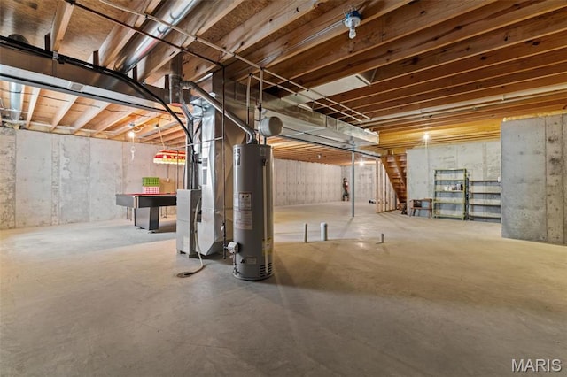 unfinished basement with gas water heater and heating unit