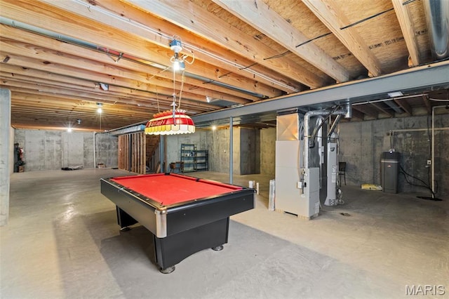 game room featuring concrete flooring, heating unit, gas water heater, and pool table