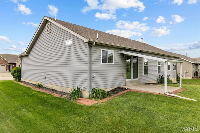 back of house featuring a lawn and a patio area
