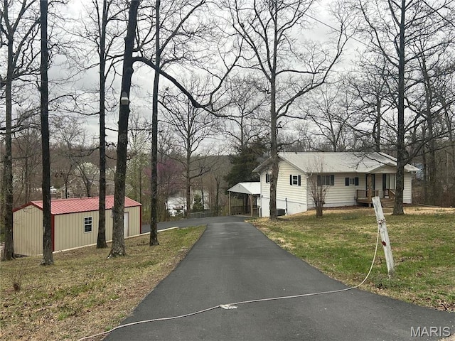 204 Wayne 521, Wappapello, MO 63966 - view of front of house with a front yard, an outbuilding, and asphalt driveway