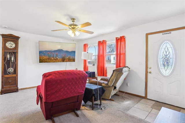 entryway with plenty of natural light, ceiling fan, carpet, and baseboards