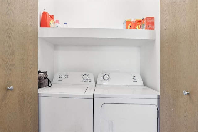 clothes washing area with washer and clothes dryer