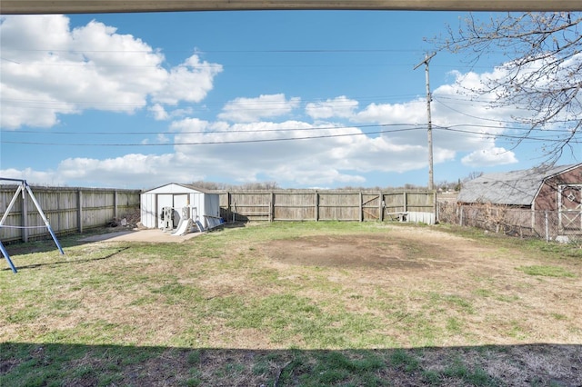 view of yard featuring a shed and an outbuilding