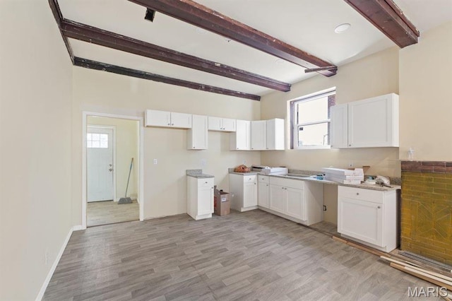 4 Lewis Pl, Saint Louis, MO 63113 - kitchen with beam ceiling, white cabinets, light wood-style floors, and baseboards