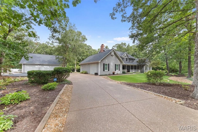 view of front of house featuring a chimney and a front lawn