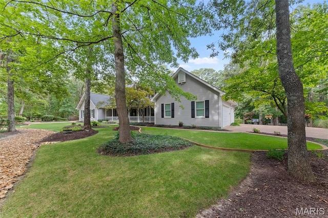 view of front facade featuring a front yard, a garage, and concrete driveway
