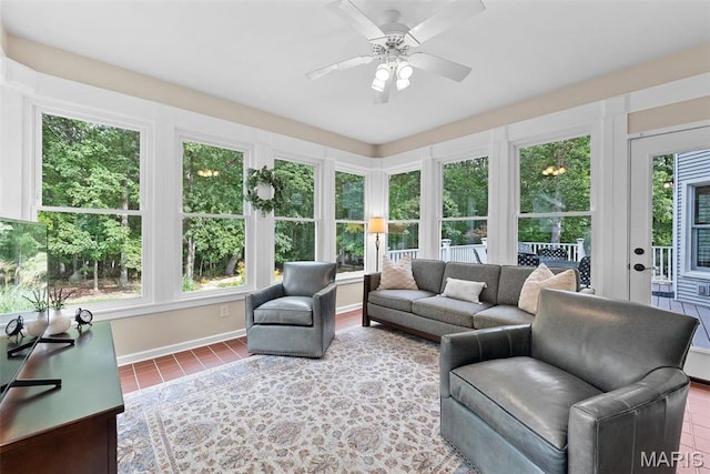 sunroom / solarium featuring tile patterned floors and baseboards