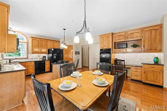 dining space featuring light wood finished floors
