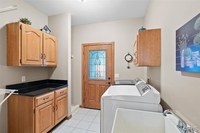 clothes washing area featuring cabinet space, separate washer and dryer, and light tile patterned flooring