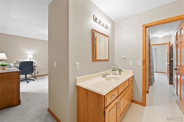 bathroom featuring baseboards and vanity