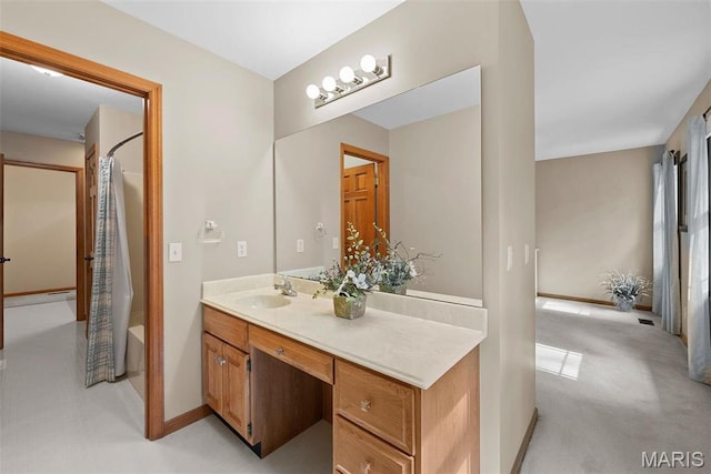bathroom featuring shower / tub combo with curtain, vanity, and baseboards