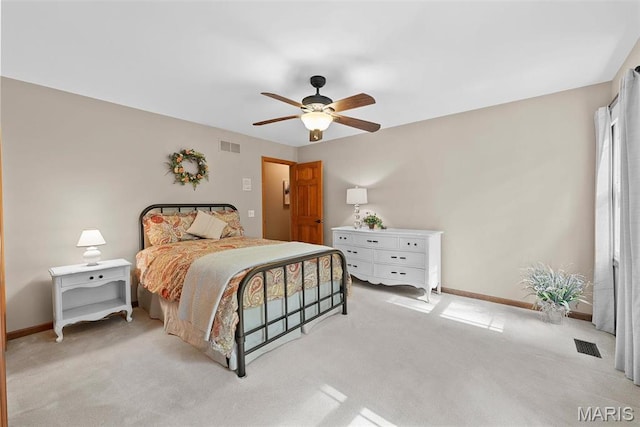 bedroom featuring light carpet, baseboards, and a ceiling fan