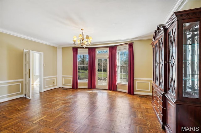 910 Kent Rd, Ladue, MO 63124 - foyer entrance featuring a chandelier, wainscoting, ornamental molding, and a decorative wall