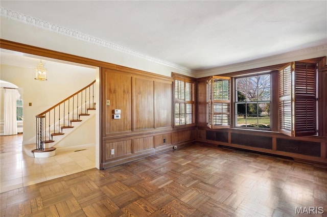910 Kent Rd, Ladue, MO 63124 - spare room featuring arched walkways and stairs