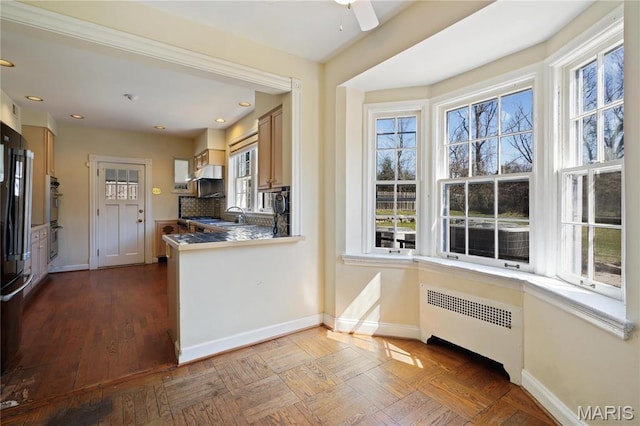 910 Kent Rd, Ladue, MO 63124 - kitchen with radiator, stainless steel double oven, freestanding refrigerator, a ceiling fan, and recessed lighting