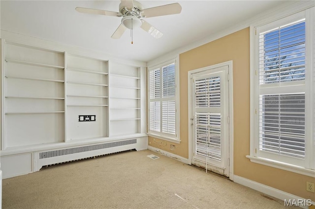 910 Kent Rd, Ladue, MO 63124 - empty room with carpet flooring, radiator heating unit, and ceiling fan